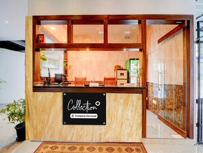 A reception desk with a sign reading 'Collection & Company Serviced.' - Super Collection O Vazhakkala Kakkanad (Kanayannur)