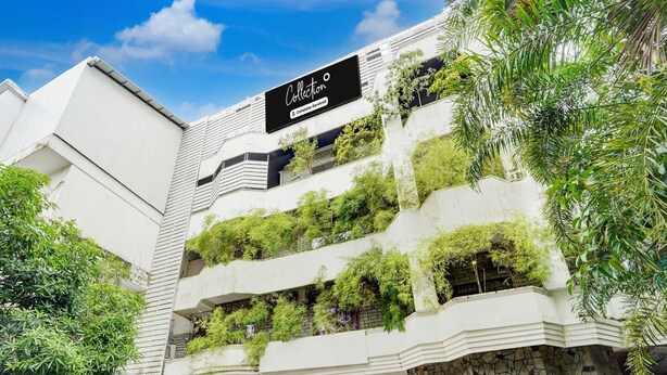 A multi-story building with a sign reading 'Collection' and 'Company Serviced'. - Super Collection O Vazhakkala Kakkanad (Kanayannur)