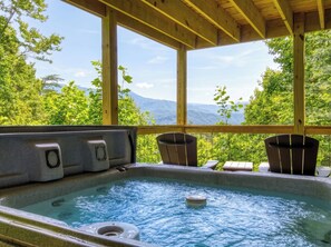 A hot tub with a wooden deck and a view of mountains. - Octagon Chalet: Hot Tub, Pool Table & Stunning Mountain Views - Sleeps 6 (Gatlinburg)