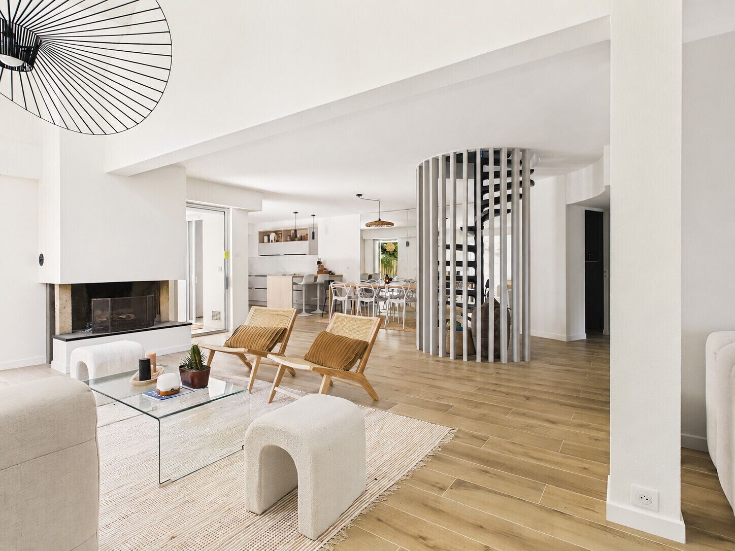 A spacious living area with a fireplace, a dining area, and a kitchen.