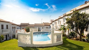 A swimming pool surrounded by white fences, with a clear blue sky above. - Hacienda 4A by Casasol (Nerja)