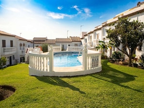 A swimming pool surrounded by white fences, with a clear blue sky above. - Hacienda 4A by Casasol (Nerja)