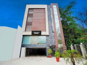 A modern building with a sign reading 'TOWNHOUSE Company Services.' - Townhouse South Delhi (New Delhi)