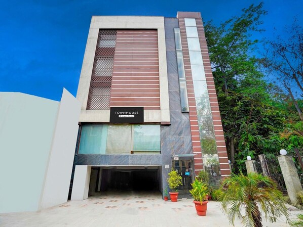 Un bâtiment moderne sur lequel on peut lire l’inscription : « Services de la société TOWNHOUSE ».