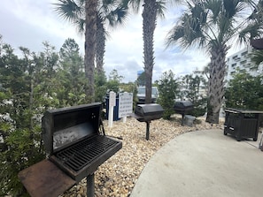 A barbecue grill area with a sign prohibiting dogs, a no grilling sign, and a clean-up instruction sign. - Grand Caribbean 214 • Fully Renovated • Walk to Beach• Sleeps 6 (Orange Beach)