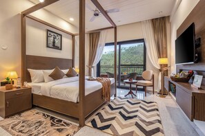 A four-poster bed, a television, a dining area, and a balcony with a view. - ELIVAAS Panchvati Veloraa 6BHK (Solan)
