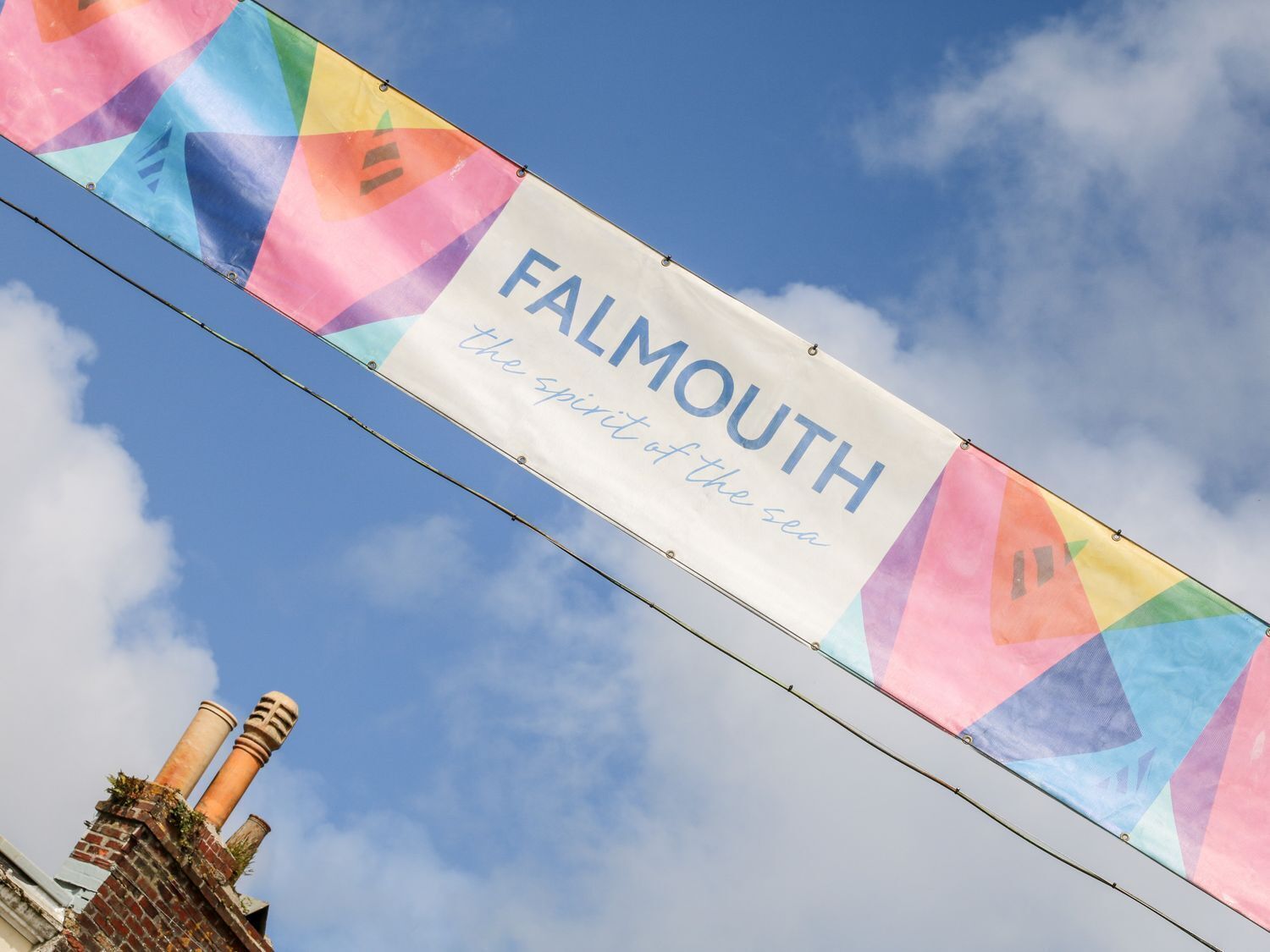 A banner with the text 'Falmouth the spirit of the sea' against a blue sky.
