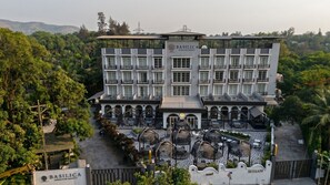 A multi-story hotel with a central courtyard, balconies, and a sign indicating it is a 5-star establishment.