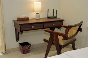 A wooden desk with a lamp, a box, and a chair. - Bani Park Boutique · Modern Luxe 2BR Apartment (Jaipur)