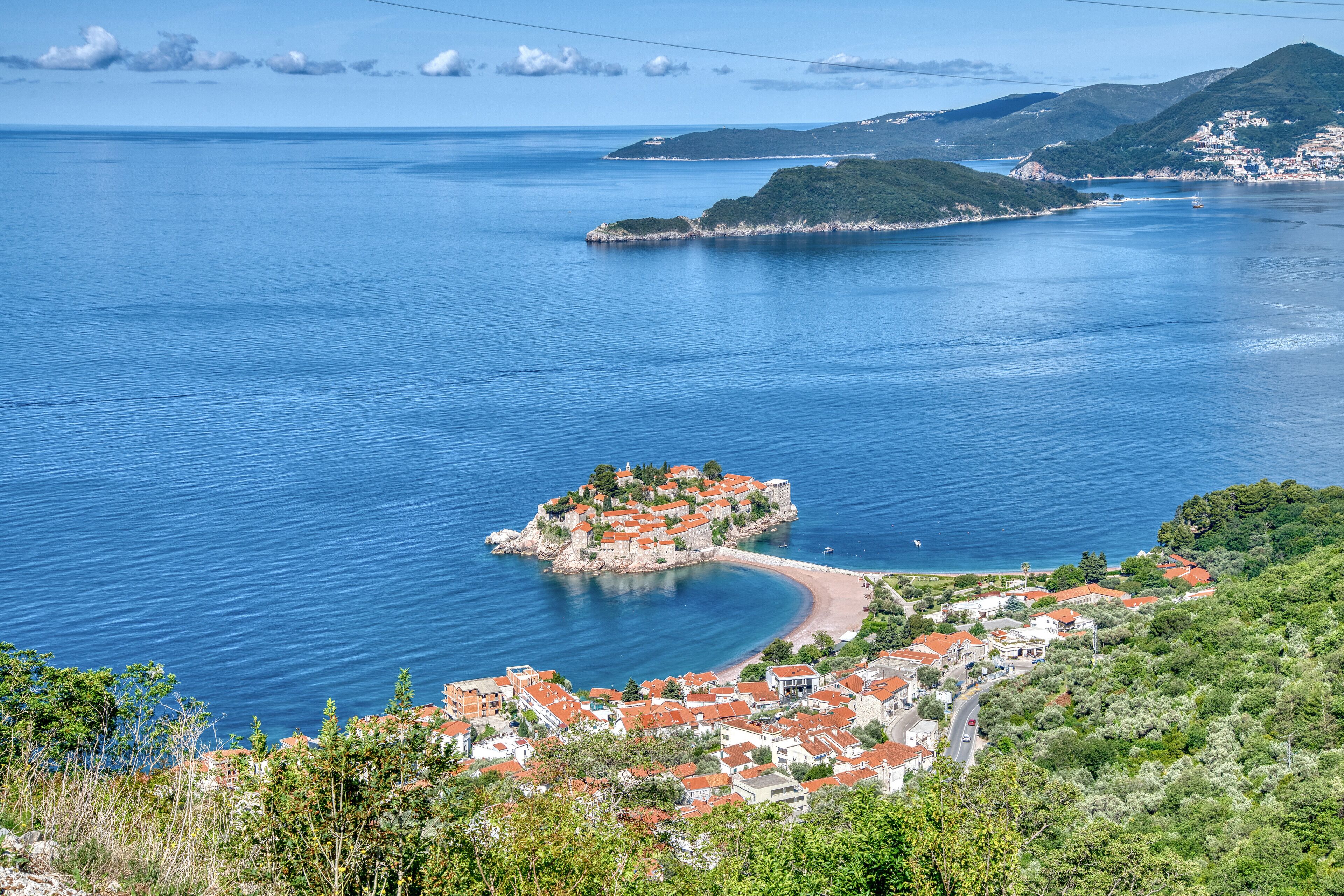 Une ville côtière qui abrite une île remarquable, avec des bâtiments historiques et une baie en forme de croissant.