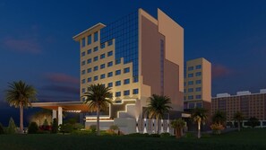 A multi-story hotel with a modern design, featuring a prominent entrance with a covered area and palm trees. - Pride Plaza Indore (Indore)