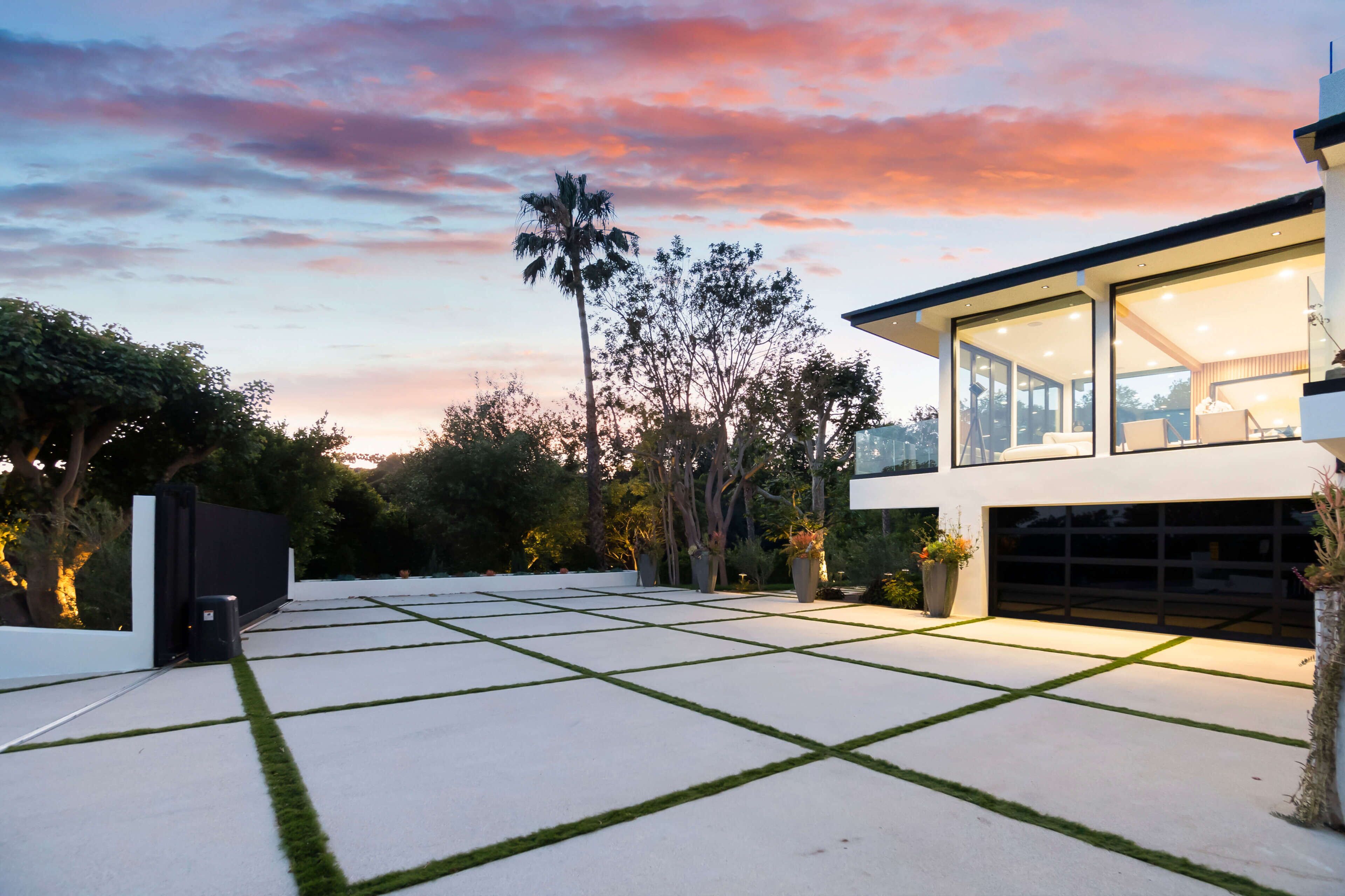 A modern house with a spacious patio, large windows, and a garage.