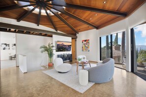 A spacious living area with a high ceiling, a large window, and a view of the outdoors. - Via Vallarta (Encino)