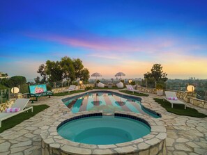 A rooftop pool with lounge chairs and a view of the city skyline. - Beverly Tree House (Beverly Hills)