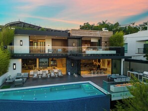 A modern two-story house with a swimming pool, outdoor seating, and a large living area. - Sierra Mar (West Hollywood)