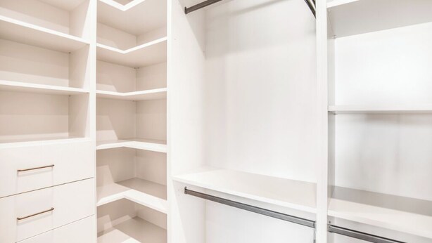 A white closet with open shelves and a metal rod. - Villa Camellia (Studio City)