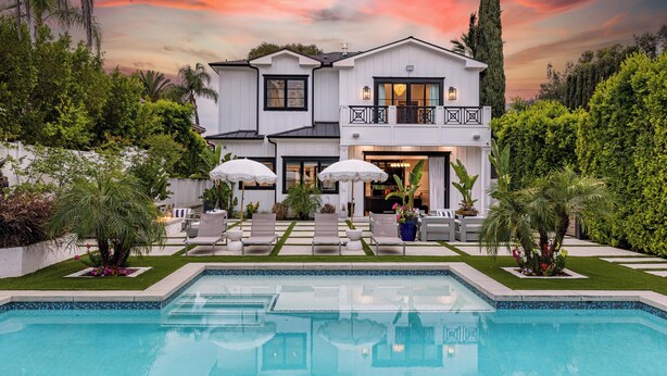 A two-story house with a swimming pool, outdoor seating, and a well-maintained garden. - Otis Ave (Tarzana)