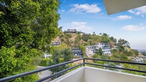 A balcony with a view of hillside houses and greenery. - Franklin Mediterranean Villa (West Hollywood)