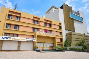 A hotel with multiple floors, a sign for 'Ace Hotel Select Akshar Imperial,' and a 'Plywood & Hardware' store on the ground floor. - Aceotel Select Akshar Imperial Morbi (Morbi)