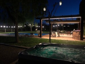 A hot tub, outdoor seating, and a pool in a backyard setting. - Villa in Llofriu with Pool (Palafrugell)