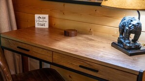 A wooden desk with a sign reading 'ON MOUNTAIN TIME,' a lamp, and a bear statue. - 2BR w/Hot Tub*Fire Pit*Games*Privacy*Walk to Pool! (Sevierville)