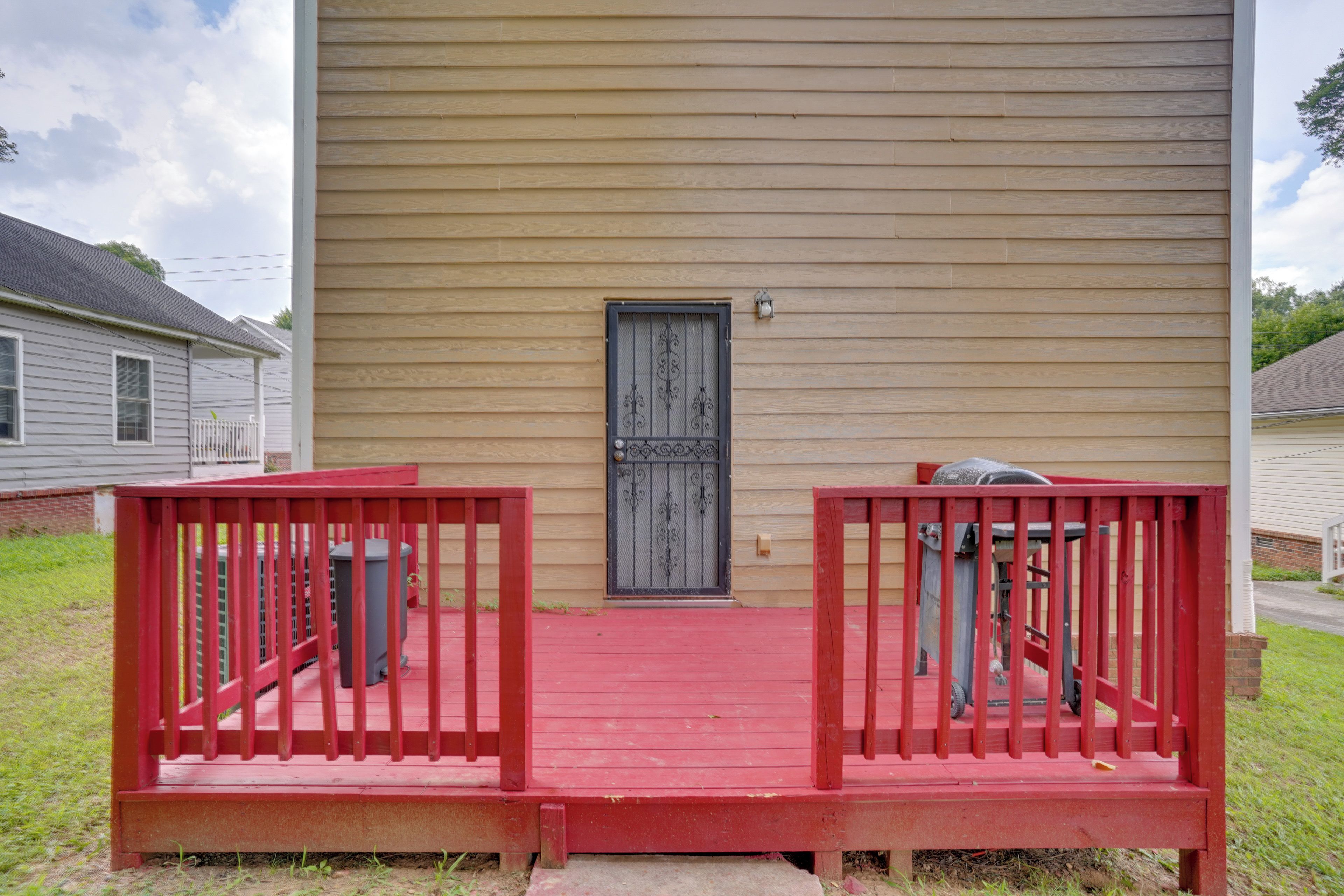 A house with a red porch and a black door.