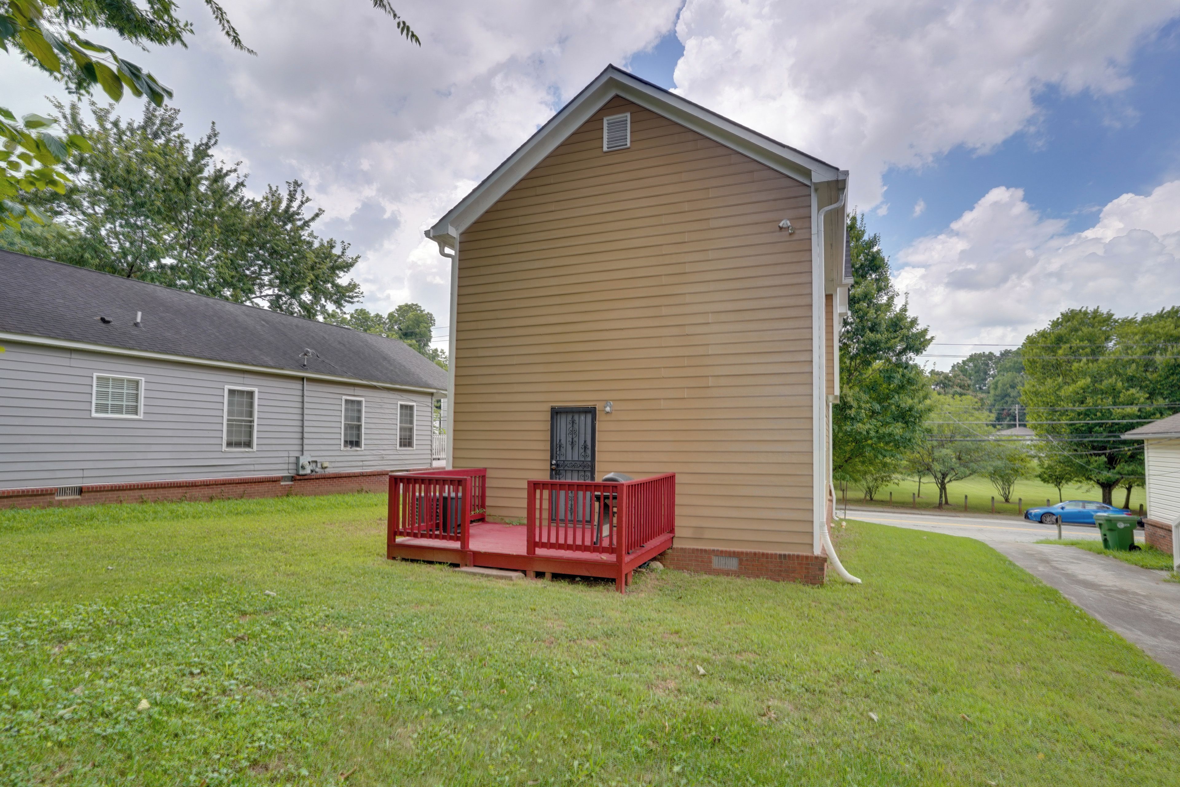 A single-story building with a red porch and a small window.