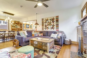 A living room with a sofa, coffee table, and a fireplace.