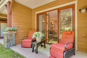 A wooden exterior with a sliding glass door leading to an interior space. - Riverfront Ski-in/ski-out Condo at Loon Mountain (Lincoln)