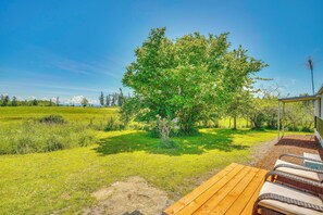 A wooden deck with lounge chairs, a tree, and a clear sky. - Stunning View! Peaceful Family Home w/ Yard in Roy (Roy)