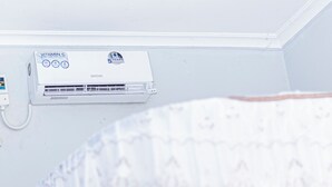 A white air conditioning unit with a 'Vitamin C' label and a '5 Years Warranty' sticker. - Marindo Lodge Moshi (Moshi)