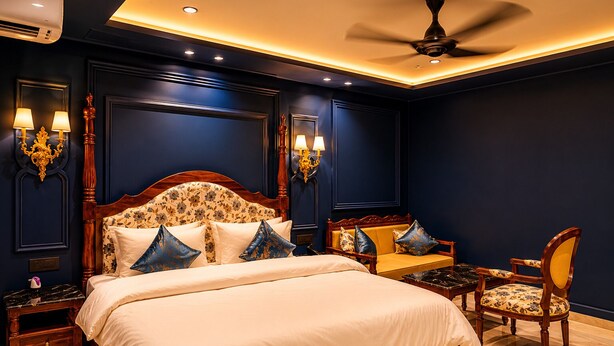 A bedroom with a large bed, a sofa, a chair, and a ceiling fan. - Hotel Casa Brij Boutique Near Nakki Lake, Mount Abu (Mount Abu)
