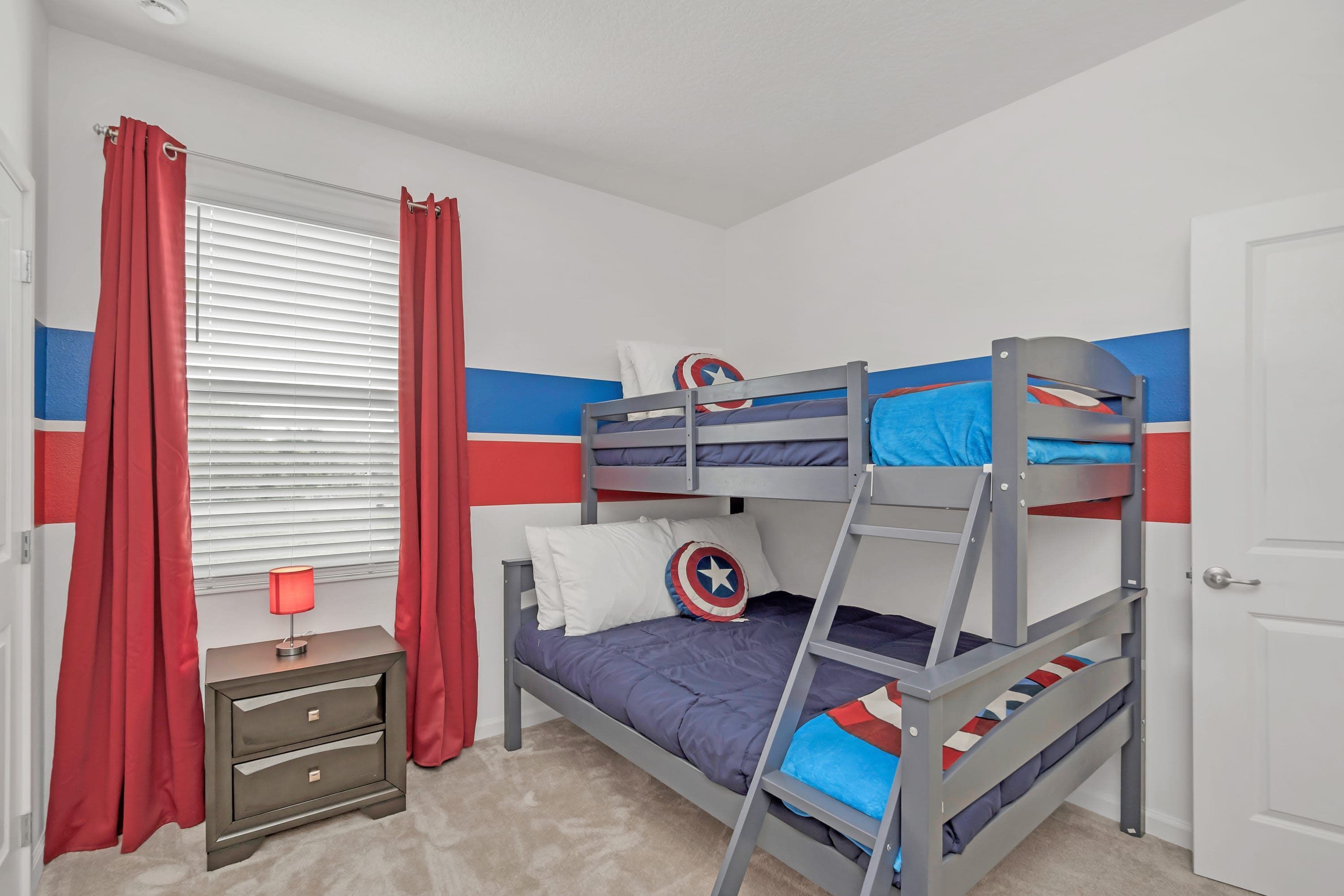 A bunk bed room with a nightstand, curtains, and a lamp.