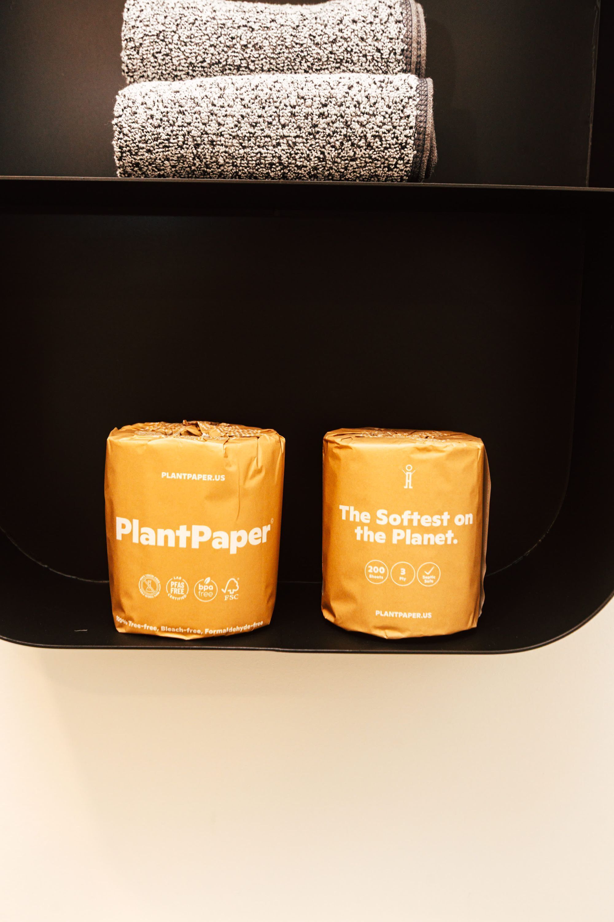 Two PlantPaper products in a black shelf.