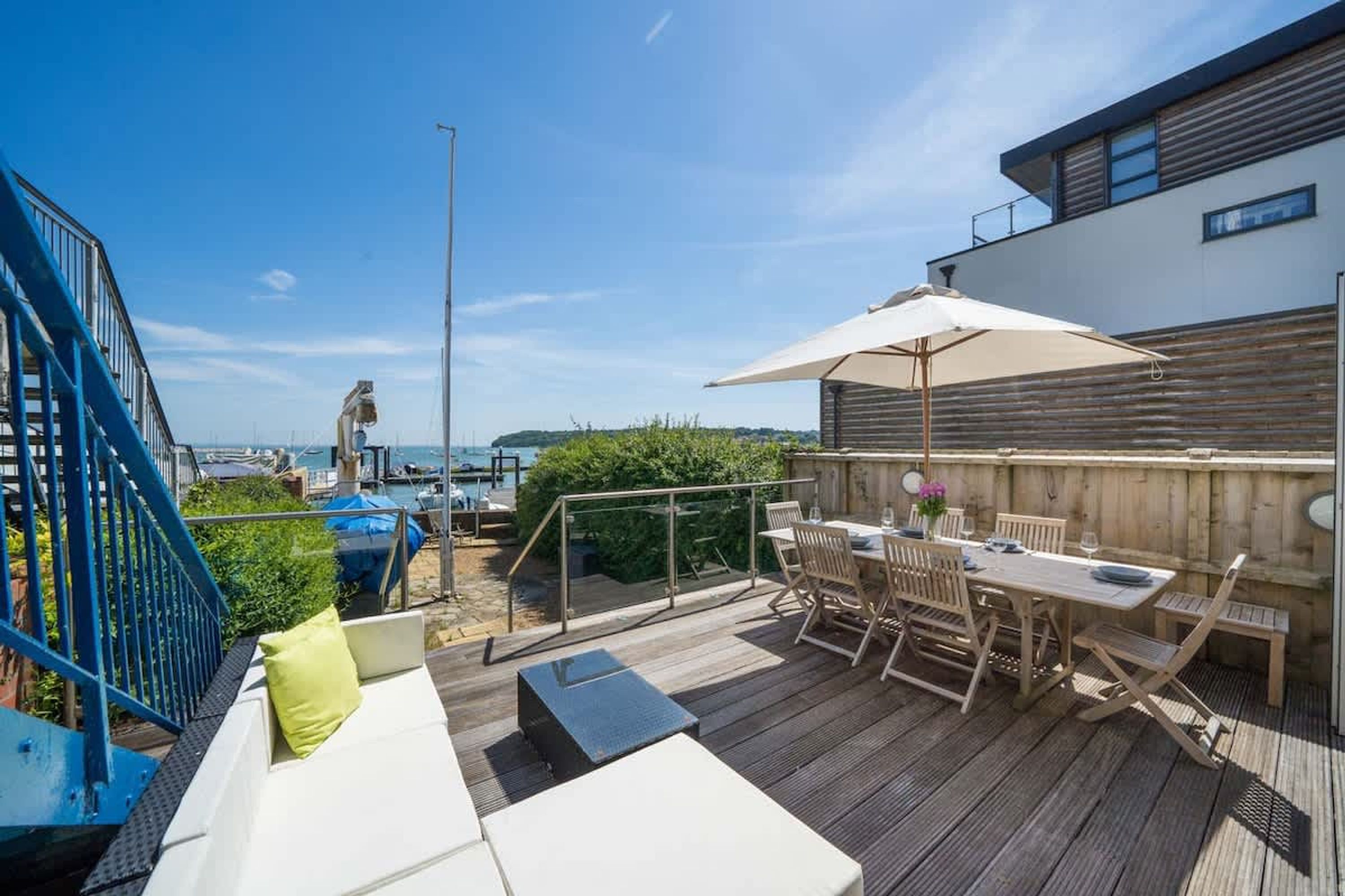 A deck with outdoor furniture, a table, and a chair.