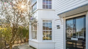 A corner of a white building with a bay window, a black door, and a number '24B' sign. - Park View 5 Bedroom Home With Solent Park Views (Cowes)