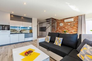 Appartement Deluxe, balcon, vue ville | Coin séjour | Télévision