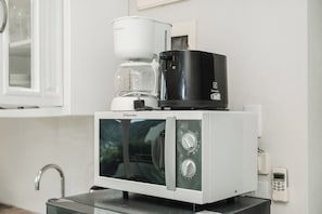 A compact kitchenette with a microwave, coffee maker, and a small refrigerator. - Panoramic 1BR, Pool, Sauna & Sea Views C196 (Karon)