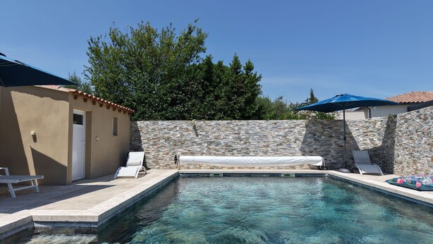 A swimming pool with stone walls, a door, and two lounge chairs. - 12-Person Villa A/C Heated Pool office close Aix Provence (Salon-de-Provence)