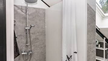 A modern shower with a rain showerhead, a handheld showerhead, and a glass-enclosed shower stall.