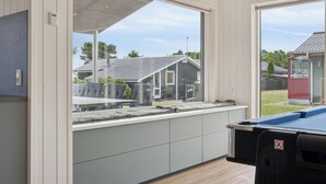 A room with a large window, a pool table, and a view of the outside. - Newly renovated holiday home near the water (Hadsund)