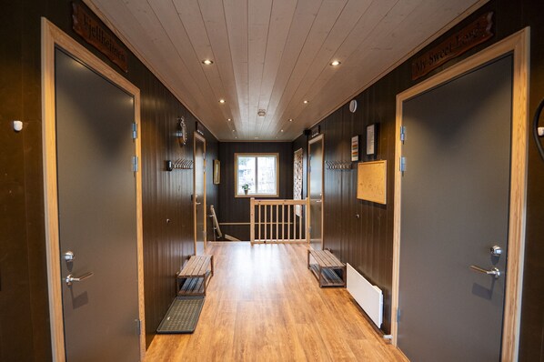 A hallway with wooden floors, dark walls, and doors labeled 'Fellheim' and 'My Sweet Love.'