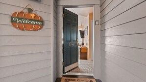 A hallway with a welcome sign, a door labeled "326A", and a doormat with "HOME Sweet HOME" text. - New Listing! River Views | Hot Tub | Near Mt. Bachelor (Bend)