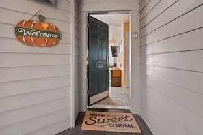 A hallway with a welcome sign, a door labeled "326A", and a doormat with "HOME Sweet HOME" text. - New Listing! River Views | Hot Tub | Near Mt. Bachelor (Bend)