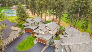 A residential area with multiple houses, each with a garage, surrounded by trees and a well-maintained lawn. - New Listing! Gorgeous Home | Hot Tub | Minutes to Mt. Bachelor (Bend)