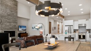 A modern kitchen with white cabinets, a stainless steel refrigerator, and a built-in oven. - New Listing! Gorgeous Home | Hot Tub | Minutes to Mt. Bachelor (Bend)