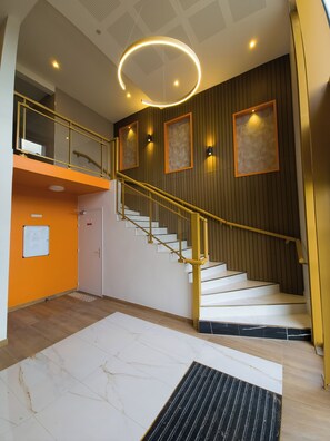 Ein modernes Interieur mit einer Treppe, einer Zwischenebene und einer runden Leuchte.