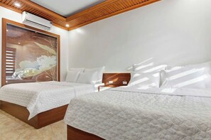 A hotel room with two beds, a large window with blinds, an air conditioning unit, and a wooden ceiling. - Tam Coc Lotus Homestay (Nam Hoa Lu)