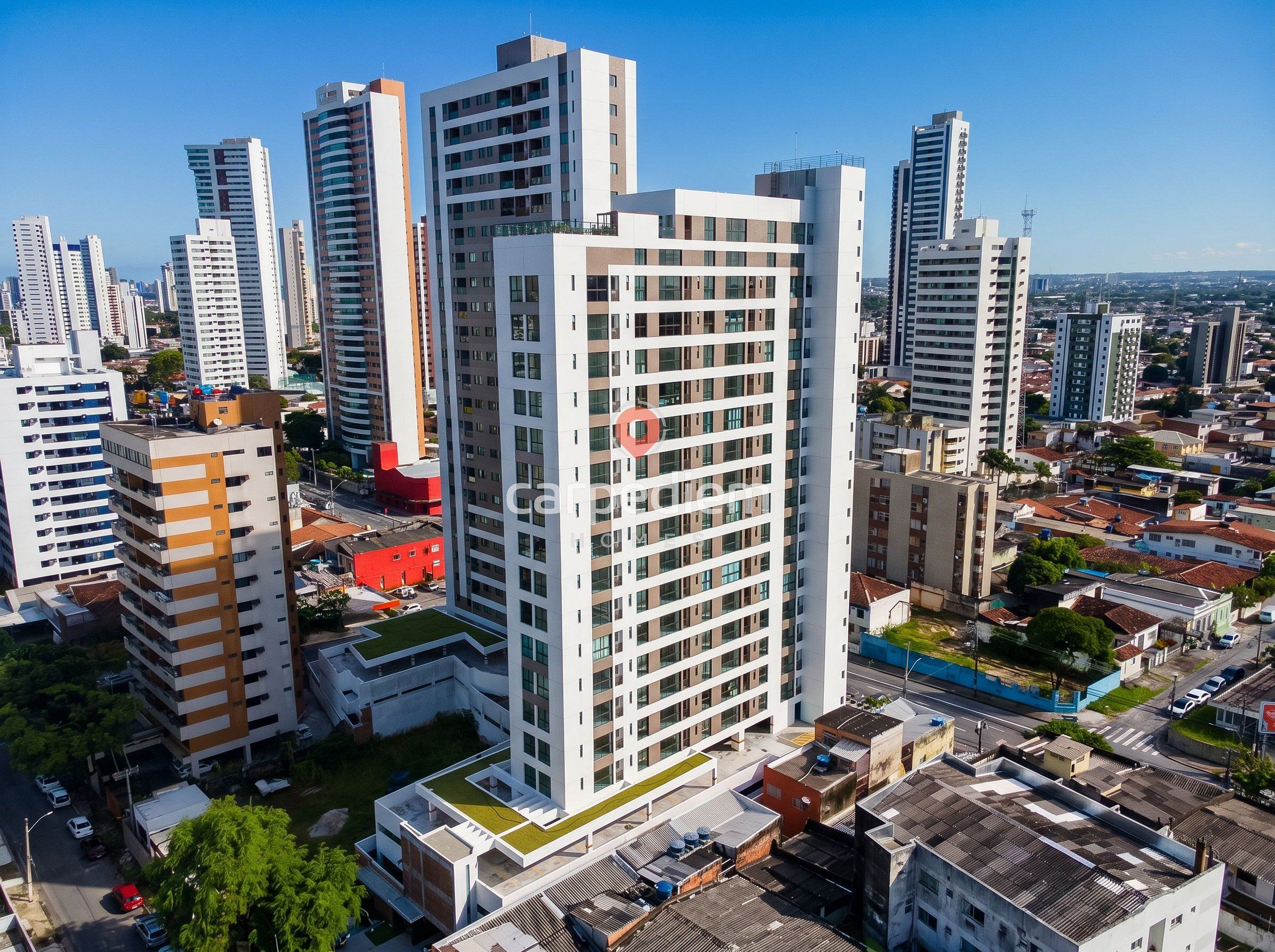 Um edifício alto com vários andares, cercado por outros edifícios altos em um ambiente urbano.