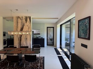 A modern interior with a dining area, kitchen, and living space.